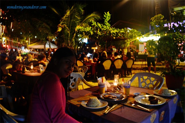 Alona Beach Panglao at Night A woman about to take her dinnerin Alona Beach Panglao