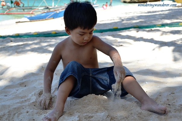 Child playing sand on Alubihod Beach - Guimaras