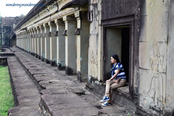 Lady at the pillars of Angkor Wat