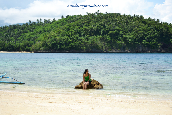 Lady on a yellow rock by the beach