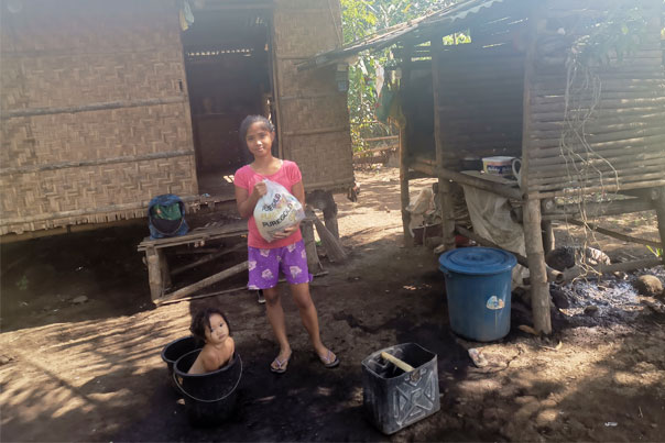 A grateful lady after receiving a food pack