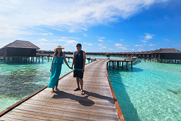 Crystal clear blue water below the Overwater Villas of the Maldives